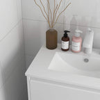 Corner view of high gloss white bathroom vanity with rectangular sink basin and tap hole