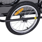 Front wheel of black bike cargo trailer with orange reflector and 16-inch tire