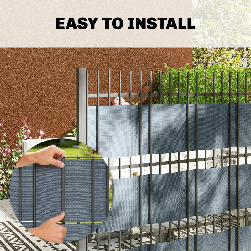 Grey privacy screen fence panel held for installation with attachment points