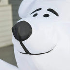 Close-up of white inflatable bear face with black nose and smile