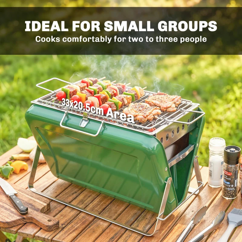 Green portable BBQ grill with wire grate cooking meat and vegetables