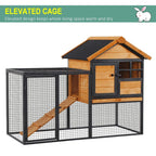 Elevated pet hutch with wire mesh enclosure, wood house top, black frame, and ramp