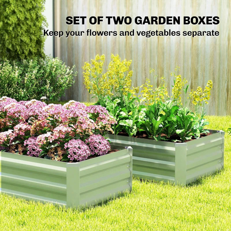Set of two light green steel raised garden planter boxes filled with flowering plants