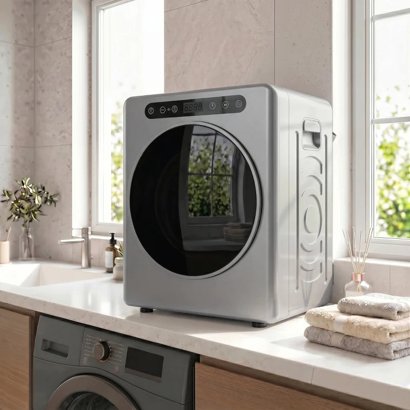 Silver compact tumble dryer on counter next to a washer, round door visible
