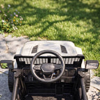 White kids electric ride-on car dashboard close-up with steering wheel and grille