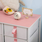 Pink tabletop on fabric drawer storage cabinet with gray drawers and pink tab handle