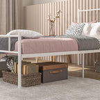 White metal single bed frame with slatted base and under-bed drawers; side view