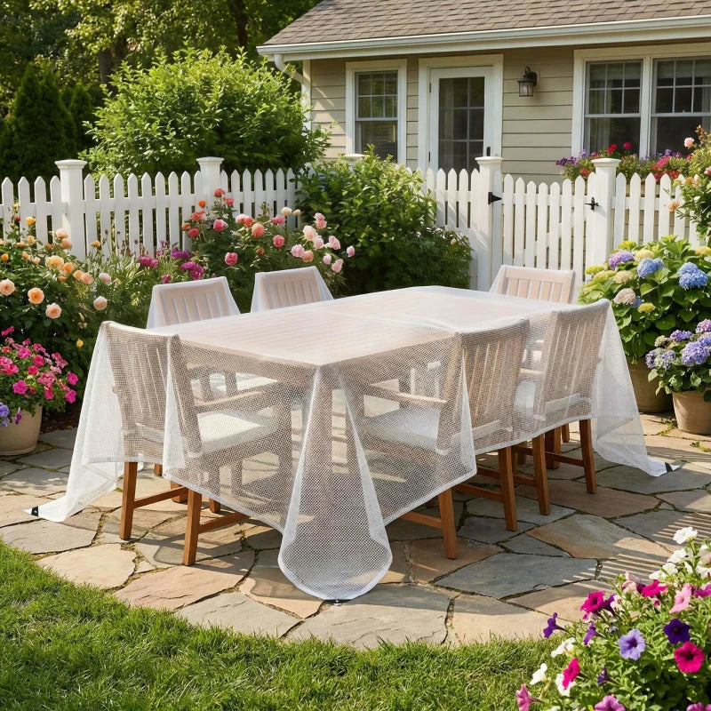 White waterproof mesh tarpaulin draped over patio dining set with hanging edges