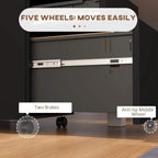 Underside view of black filing cabinet showing five wheels, two brakes, and anti-tip wheel