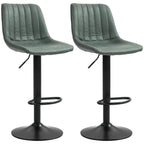 Set of two green retro bar stools with tufted seats, footrests, and black bases