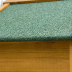 Close-up of green asphalt roof texture on a natural wood shed cabinet