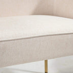 Cream upholstered chair cushion with subtle textured fabric close-up