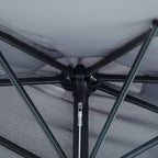 Underside view of grey half parasol canopy with central hub and support ribs