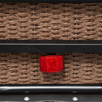 Red reflector on wicker cargo panel of black bicycle trailer