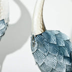 Steel crane ornament wing detail with blue scales and white tail feathers