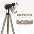 Spotlight head on adjustable tripod floor lamp with black housing and wood-tone legs