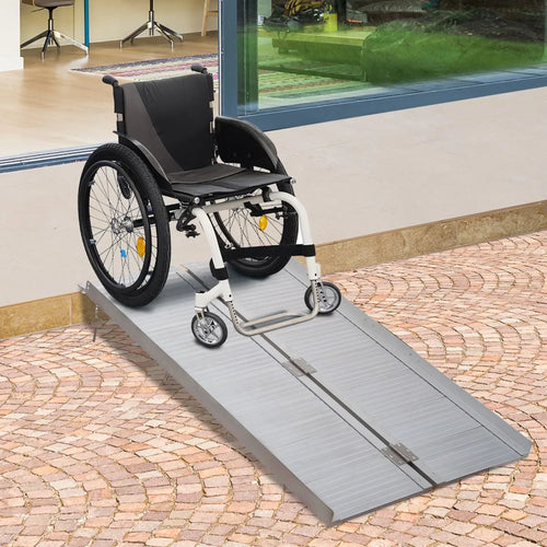 Aluminum folding wheelchair ramp with wheelchair positioned on textured surface for access