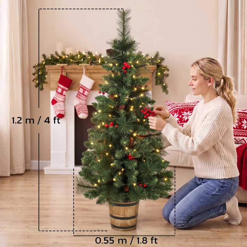 4 ft prelit Christmas tree in a pot with green needles, pinecones and berries, warm LED glow