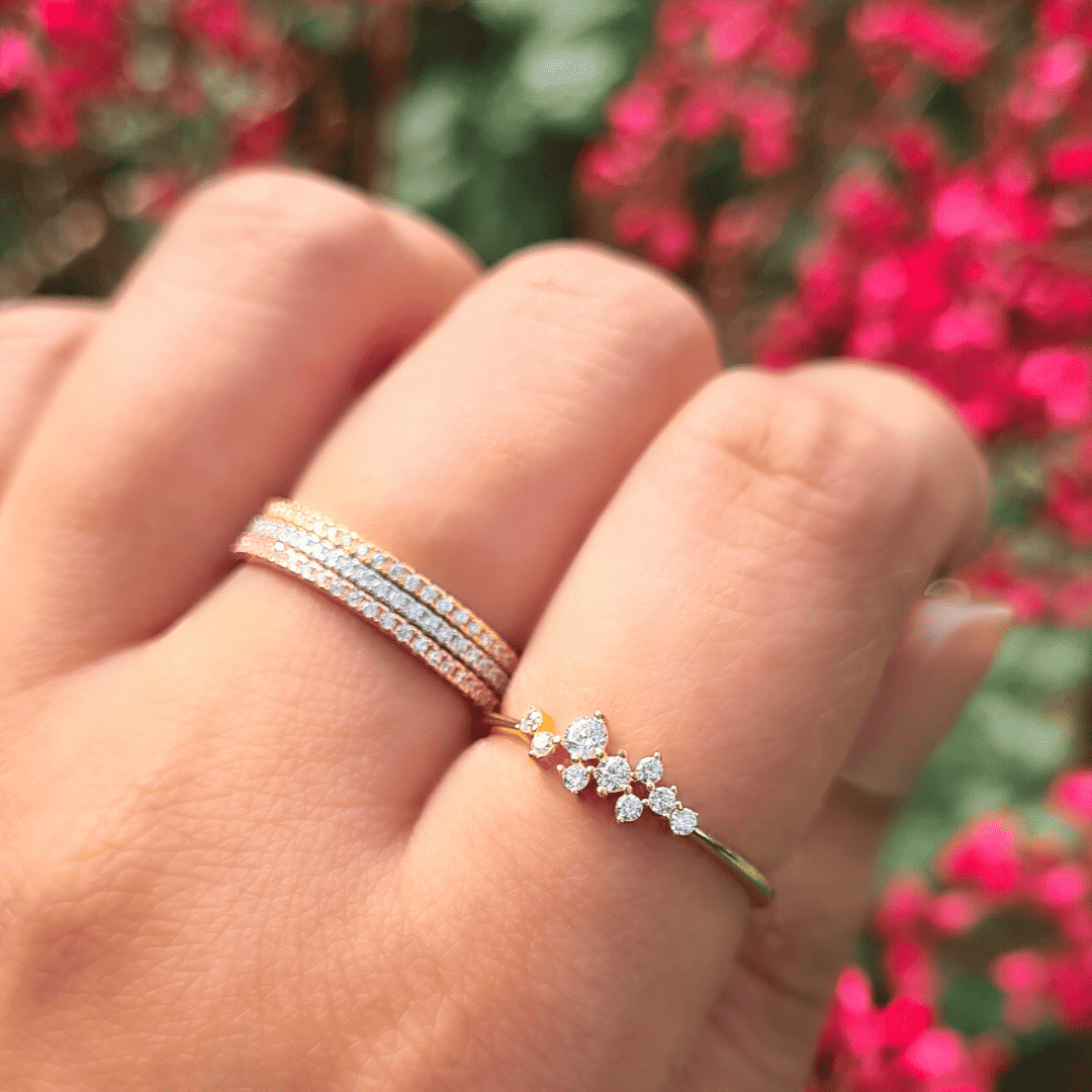 Two stacked gold-tone eternity rings with pavé crystals