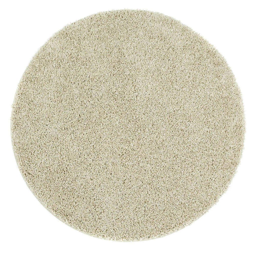 Washable shaggy rug, round beige textured pile close-up
