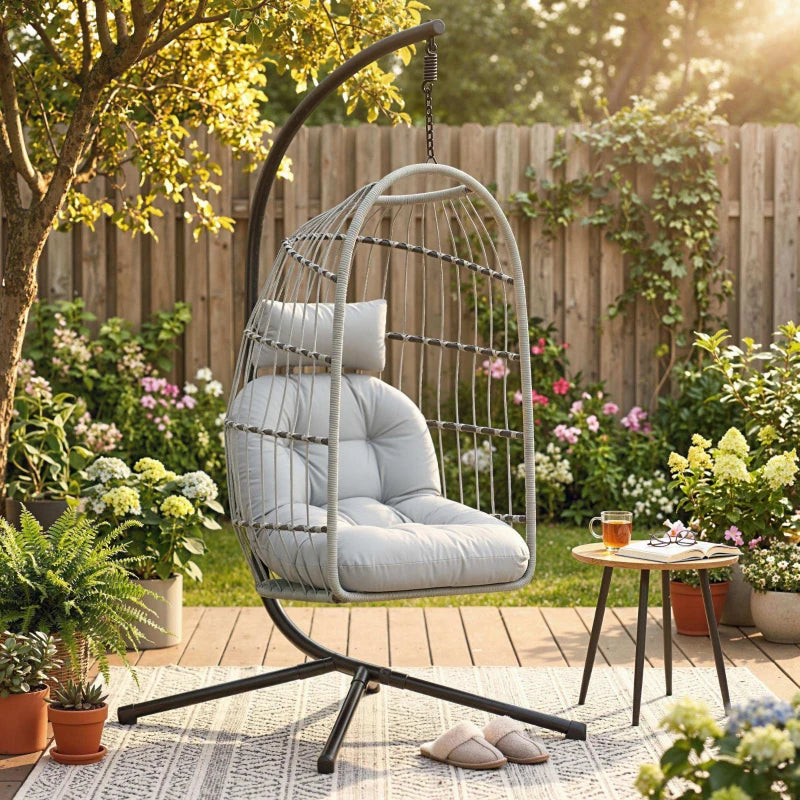 Light grey hanging egg chair with wire shell, padded cushion, and hanging chain