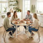 Round folding dining table with light wood top and white steel legs, set for a meal
