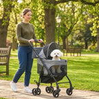 Grey foldable pet stroller with mesh sides, canopy, and a dog inside