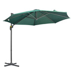 Green cantilever patio umbrella with crank handle and cross base, open canopy