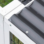 Close-up of white wooden hutch corner with black roof panel and metal screws