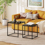 Two black nesting side tables with tempered glass tops and a metal frame in living room
