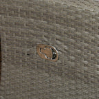 Close-up of metal logo plate on grey woven rattan furniture