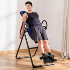 Gravity inversion table with blue padded backrest and ankle pads in an upright position