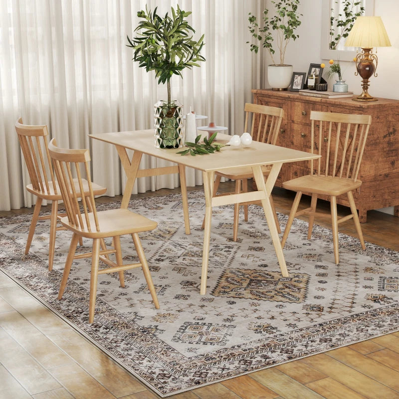 Beige vintage rug beneath dining table, with detailed medallion and border design