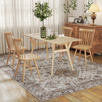 Beige vintage rug beneath dining table, with detailed medallion and border design