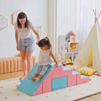 Toddler playing on pink and blue foam climber slide and stairs