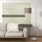 Grey linen-look drum lampshade on sleek white metal pole floor lamp