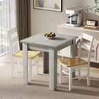 Grey square-corner extendable dining table with straight legs and four chairs.