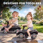 Matte black ride-on push car with seat and steering wheel, front profile view