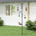 Black outdoor bird feeding station with hanging feeders on a vertical pole