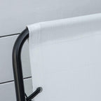 Close-up of cream mesh fabric edge and black metal armrest frame on folding chair