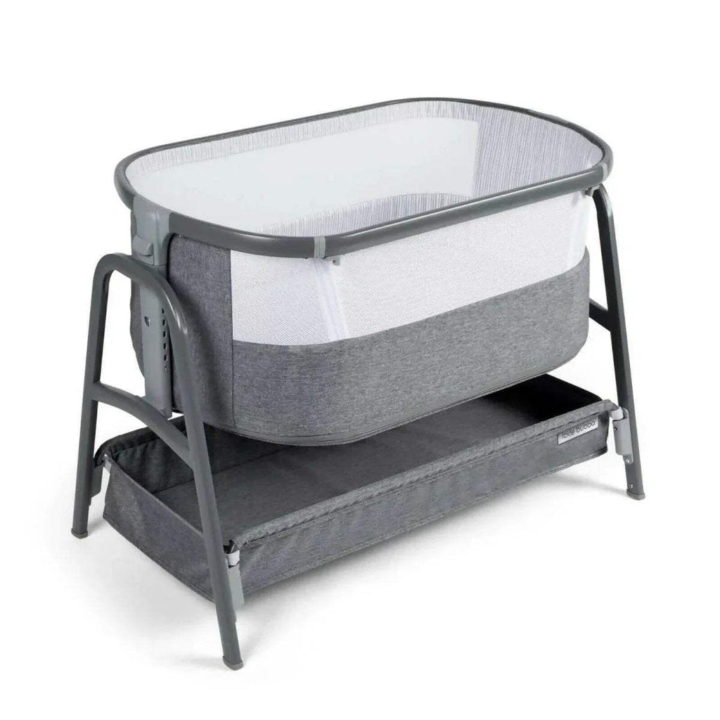 Grey bedside crib with curved frame, padded fabric base, and breathable mesh sides.