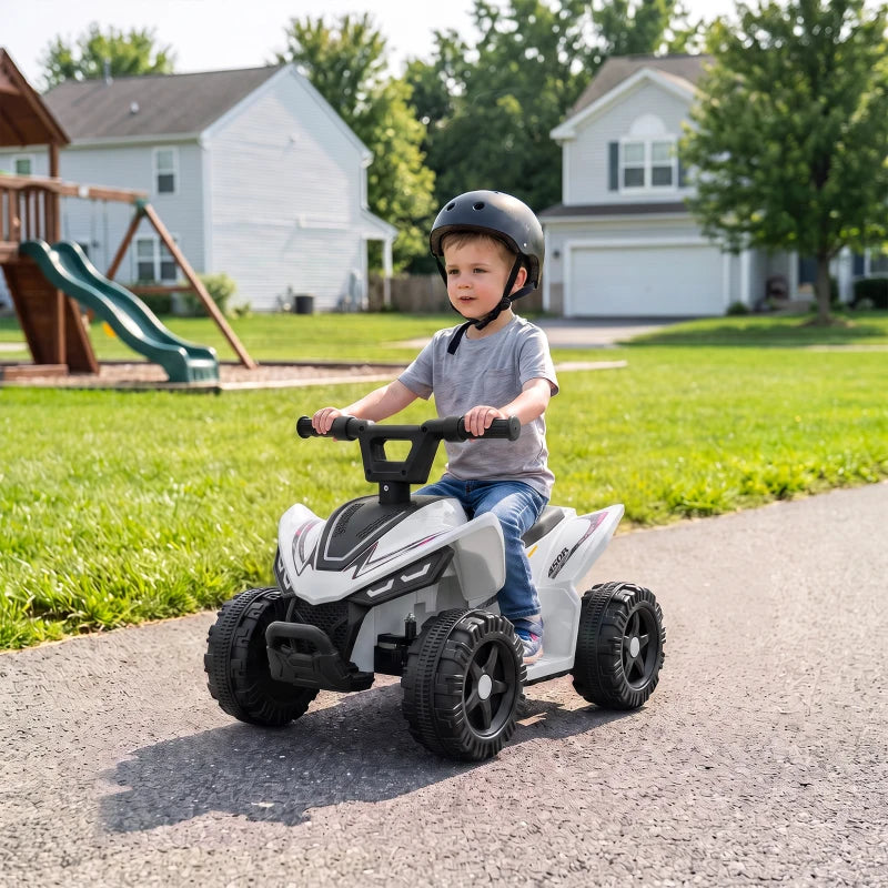 White kids quad bike with black handlebar, child seated and riding on gravel path