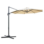 Beige round patio umbrella parasol with open canopy and cross-frame base