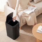 Black automatic sensor trash bin with open lid and rounded top edge
