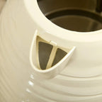 Beige kettle spout filter insert, close-up inside the spout