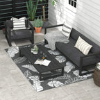 Grey-and-white leaf-pattern outdoor rug on patio under dark furniture