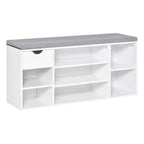 White shoe storage bench with grey cushion and open cubbies for shoes