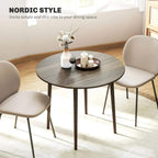 Grey round drop-leaf dining table with wood legs, minimalist Nordic dining setup