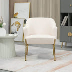 Cream upholstered accent chair with gold legs in a styled room setting