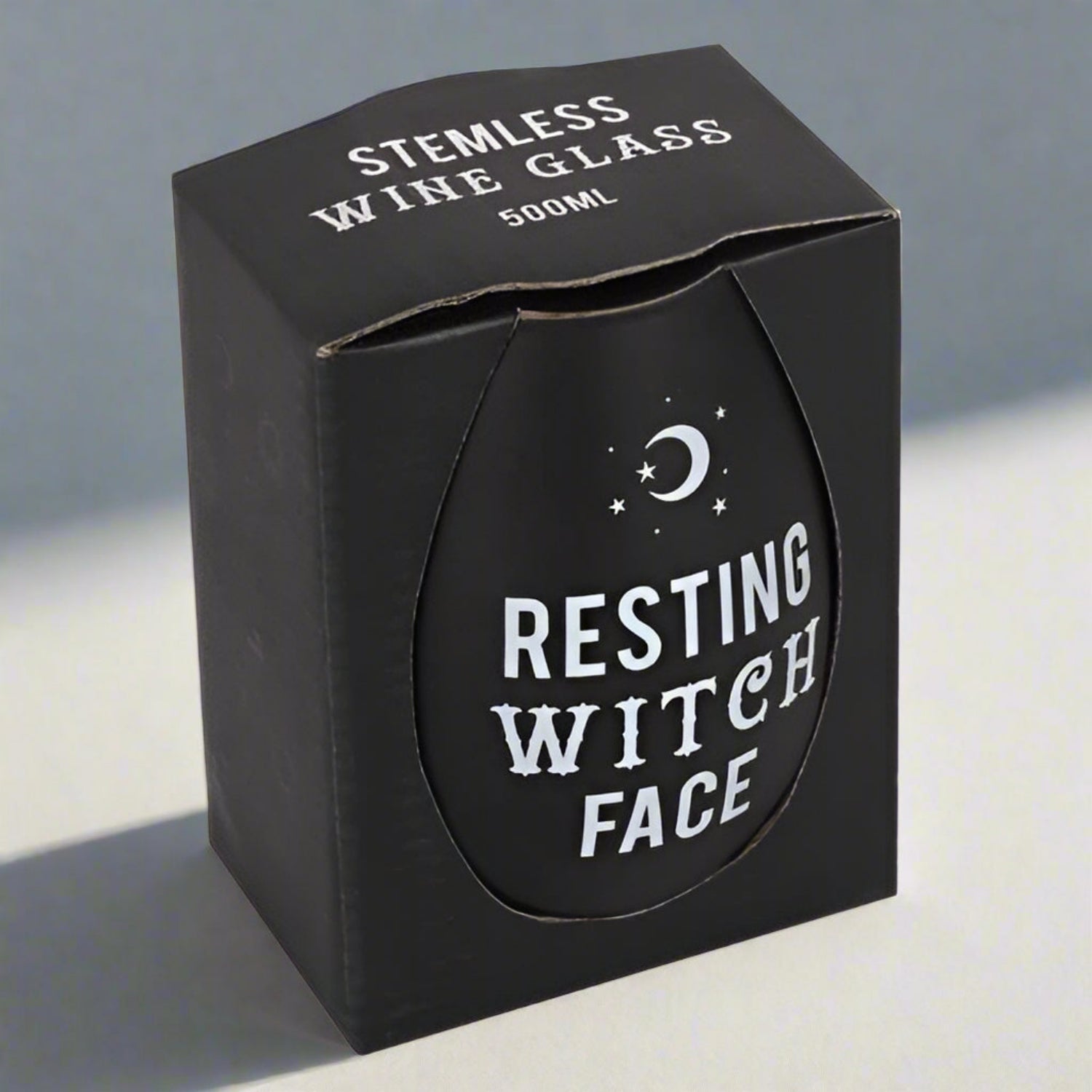 Black stemless wine glass packaging with 'Resting Witch Face' text and moon design.